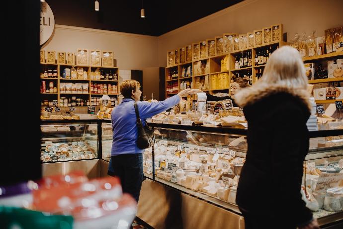 man in blue jacket standing in front of counter